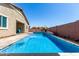 Stunning pool with waterfall feature, seamlessly blending relaxation and entertainment in a private backyard oasis at 45975 W Mountain View Rd, Maricopa, AZ 85139