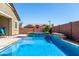 Inviting swimming pool with a waterfall feature, surrounded by manicured landscaping in a private backyard oasis at 45975 W Mountain View Rd, Maricopa, AZ 85139