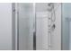 Modern walk-in shower featuring sleek chrome fixtures and a built-in storage shelf at 45975 W Mountain View Rd, Maricopa, AZ 85139