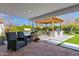 Covered patio with outdoor kitchen, pool, lush landscaping and comfortable seating at 4739 N 34Th Pl, Phoenix, AZ 85018