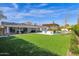 Expansive backyard featuring a lush lawn, outdoor kitchen, pool, and mature landscaping at 4739 N 34Th Pl, Phoenix, AZ 85018
