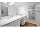 A bright bathroom featuring dual sinks, a marble countertop, and a glass-enclosed shower, with modern finishes at 4739 N 34Th Pl, Phoenix, AZ 85018