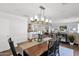 An open-concept dining room boasts a stylish chandelier and seamless transition to the kitchen and living area at 4739 N 34Th Pl, Phoenix, AZ 85018