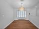 Elegant dining area with wood floors, large bay window with shutter shades, and modern lighting at 4739 N 34Th Pl, Phoenix, AZ 85018