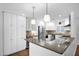 Beautiful kitchen with white cabinetry, granite countertops, stainless steel appliances, and modern lighting at 4739 N 34Th Pl, Phoenix, AZ 85018
