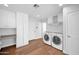 Well-lit laundry room with new appliances, storage cabinets, and tile flooring at 4739 N 34Th Pl, Phoenix, AZ 85018