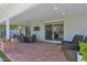 Covered patio with outdoor seating, brick flooring, and a view of the landscaped yard at 4739 N 34Th Pl, Phoenix, AZ 85018