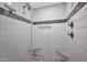 A modern bathroom shower with a mosaic accent stripe, dual shower heads, and a built-in bench at 4739 N 34Th Pl, Phoenix, AZ 85018