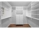 A large walk-in closet with custom shelves and drawers, providing ample storage and organization options at 4739 N 34Th Pl, Phoenix, AZ 85018