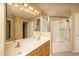 Bathroom with double sinks, large mirror, and glass door shower at 4927 E Hazel Dr # 2, Phoenix, AZ 85044