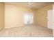 Spacious bedroom features neutral carpet, ceiling fan, and sliding door to the outside at 4927 E Hazel Dr # 2, Phoenix, AZ 85044