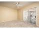 Bedroom with ceiling fan, neutral carpet and sliding doors leads to the exterior at 4927 E Hazel Dr # 2, Phoenix, AZ 85044