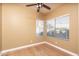 Bedroom with hardwood floors, ceiling fan and natural light from the two windows at 4927 E Hazel Dr # 2, Phoenix, AZ 85044
