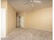 Bright, carpeted bedroom with a ceiling fan, neutral walls, and a closet with sliding doors at 4927 E Hazel Dr # 2, Phoenix, AZ 85044