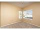 Bedroom with neutral carpet and two windows providing great natural light at 4927 E Hazel Dr # 2, Phoenix, AZ 85044