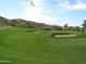 Expansive golf course with manicured green, sand traps, and desert landscape, ideal for an active lifestyle at 4927 E Hazel Dr # 2, Phoenix, AZ 85044