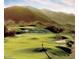 Lush golf course with rolling green hills, sand traps, and a golfer against a backdrop of majestic mountains at 4927 E Hazel Dr # 2, Phoenix, AZ 85044