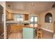 Kitchen featuring wood cabinets, stainless steel appliances, a charming island with seating, and lots of counter space at 4927 E Hazel Dr # 2, Phoenix, AZ 85044