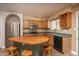 Kitchen featuring wood cabinets, stainless steel appliances, a charming island with seating, and lots of counter space at 4927 E Hazel Dr # 2, Phoenix, AZ 85044