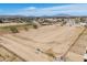 Aerial view displays the property's ample space, secured by fencing, offering potential and mountain views at 49853 W Jean Dr, Maricopa, AZ 85139