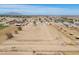 Wide aerial shot showcases the property's spacious land, complete with rural charm and distant mountain views at 49853 W Jean Dr, Maricopa, AZ 85139