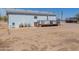 Backyard of a house with a patio, outdoor seating, and desert landscaping at 49853 W Jean Dr, Maricopa, AZ 85139