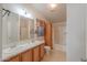 Bathroom with double sinks, a storage cabinet, and a shower-tub combo at 49853 W Jean Dr, Maricopa, AZ 85139