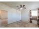 Bedroom with carpet, ceiling fan, and a window with patterned curtains at 49853 W Jean Dr, Maricopa, AZ 85139