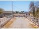 Property entrance features a gravel driveway flanked by a white fence at 49853 W Jean Dr, Maricopa, AZ 85139