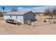 Aerial of house showing deck, white fence and desert landscaping, with blue sky above at 49853 W Jean Dr, Maricopa, AZ 85139