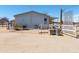 Exterior side view of a house with a fenced area and a propane tank at 49853 W Jean Dr, Maricopa, AZ 85139