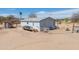 Exterior view of a single-story home with a deck, fenced area, and desert landscaping at 49853 W Jean Dr, Maricopa, AZ 85139