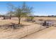 An aerial view of the fenced-in yard features a shed and tree that adds shade and tranquility to the outdoor space at 49853 W Jean Dr, Maricopa, AZ 85139