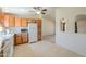 Kitchen with bright light, oak cabinets, white appliances and tile floor at 49853 W Jean Dr, Maricopa, AZ 85139