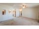 View of the living room with a ceiling fan and a cutout view to the kitchen at 49853 W Jean Dr, Maricopa, AZ 85139