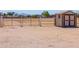 The gated property entrance offers security and leads to an adjacent storage shed for your needs at 49853 W Jean Dr, Maricopa, AZ 85139