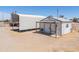 A high angle view of the property shows outbuildings and shelters, for storing equipment and ranch activities at 49853 W Jean Dr, Maricopa, AZ 85139