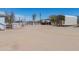 A partial view of the sprawling property including carports, gates, and buildings for rural living at 49853 W Jean Dr, Maricopa, AZ 85139