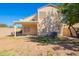 Exterior shot of backyard featuring a covered patio and a two-story home at 5057 E Dragoon Ave, Mesa, AZ 85206
