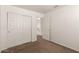 Standard bedroom featuring neutral carpet, a closet with bi-fold doors, and access to the upstairs hallway at 5057 E Dragoon Ave, Mesa, AZ 85206