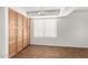 Bedroom featuring natural wood cabinets, a window, and wood floors at 5057 E Dragoon Ave, Mesa, AZ 85206