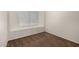 Small bedroom featuring neutral carpet, a window with white blinds, and multiple electric outlets at 5057 E Dragoon Ave, Mesa, AZ 85206