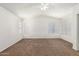 Spacious bedroom featuring neutral carpet, a vaulted ceiling, and multiple bright windows with white blinds at 5057 E Dragoon Ave, Mesa, AZ 85206