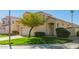 Charming home features a well-manicured lawn, desert landscaping, and a two-car garage at 5057 E Dragoon Ave, Mesa, AZ 85206