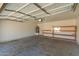 Spacious garage with shelving, water heater, and overhead lighting perfect for parking and storage at 5057 E Dragoon Ave, Mesa, AZ 85206
