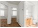Upstairs hallway with views into the bathroom and a bedroom, featuring carpet flooring and neutral walls at 5057 E Dragoon Ave, Mesa, AZ 85206