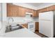 Kitchen featuring bright appliances, wooden cabinets, and sleek countertops at 5057 E Dragoon Ave, Mesa, AZ 85206