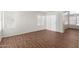 Spacious living area featuring beautiful hardwood floors and large windows at 5057 E Dragoon Ave, Mesa, AZ 85206