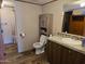 Bathroom features vanity, toilet, mirror and shower with curtain at 52150 W Cardinal S Rd, Maricopa, AZ 85139