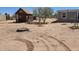 Wide shot of desert landscape with a shed, a house, and a fire pit at 52150 W Cardinal S Rd, Maricopa, AZ 85139
